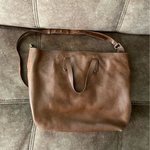 MADEWELL zip top brown leather bag, black cloth inside.